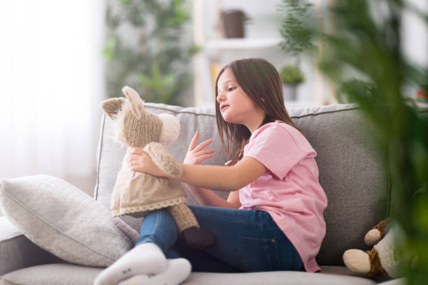 Toddler laughing while playing with musical animal toy
